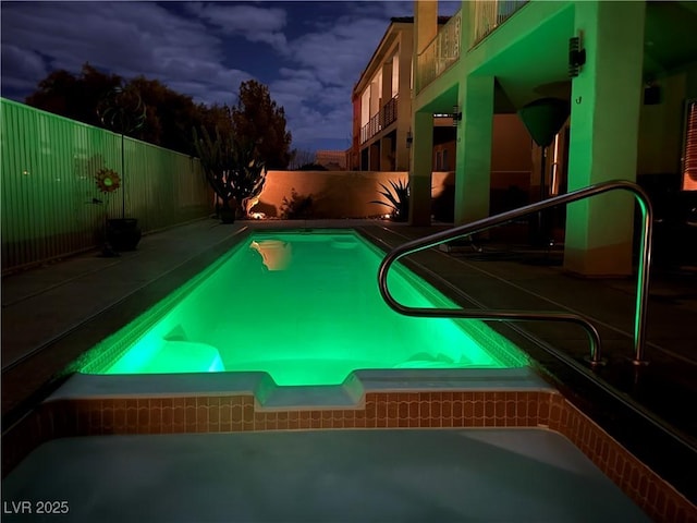 view of pool at dusk