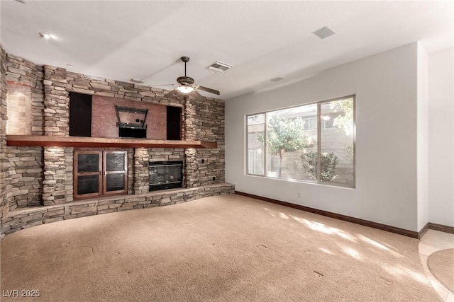 unfurnished living room featuring ceiling fan, carpet, and a fireplace