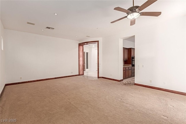 carpeted empty room featuring ceiling fan