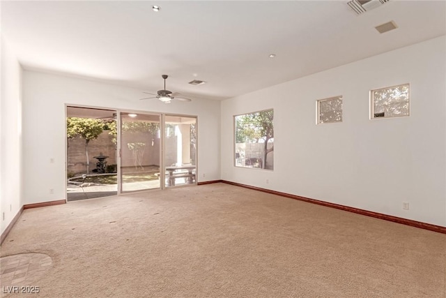 carpeted empty room featuring ceiling fan