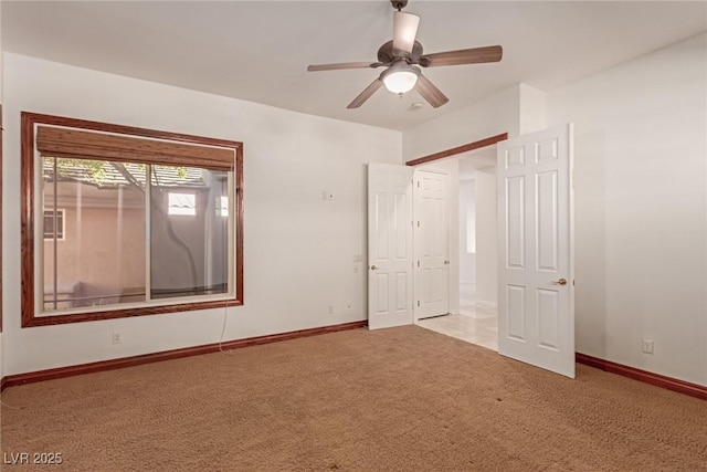 unfurnished bedroom featuring ceiling fan and light carpet