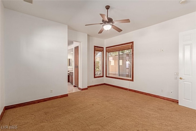 spare room featuring ceiling fan and light colored carpet