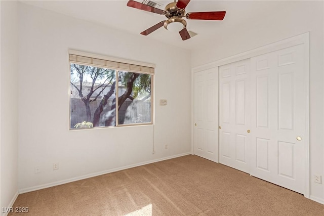 unfurnished bedroom with ceiling fan, a closet, and carpet flooring