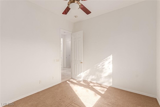 empty room with ceiling fan and light colored carpet