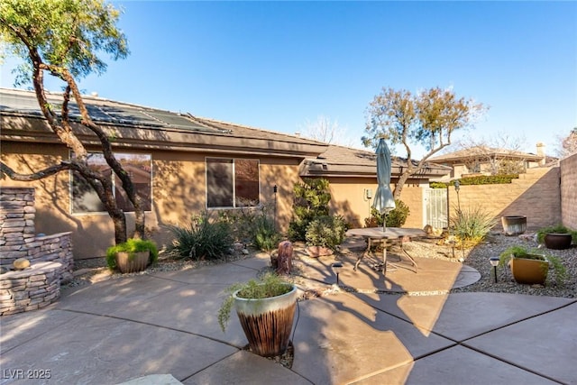 back of property with a patio