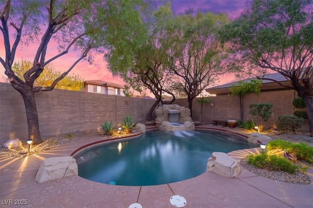 pool at dusk featuring a fenced in pool, a fenced backyard, and a patio