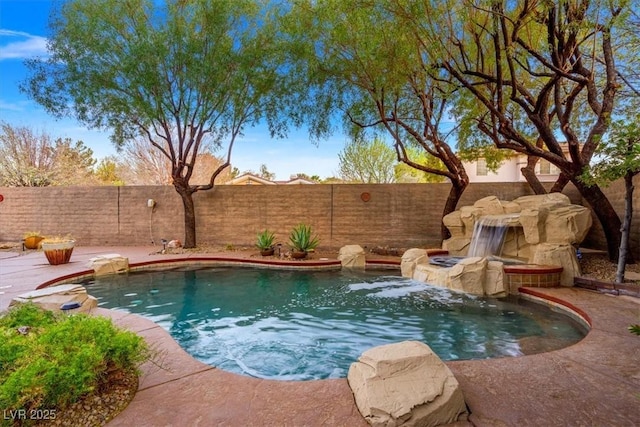 view of swimming pool featuring a jacuzzi, a fenced backyard, and a fenced in pool