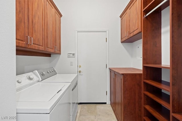 laundry area with cabinet space and separate washer and dryer