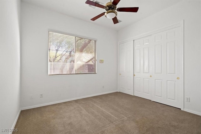 unfurnished bedroom featuring ceiling fan, a closet, carpet flooring, and baseboards