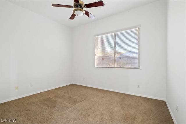 empty room with carpet floors, baseboards, and a ceiling fan