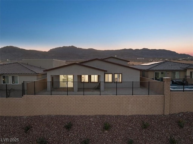 back house at dusk with a mountain view