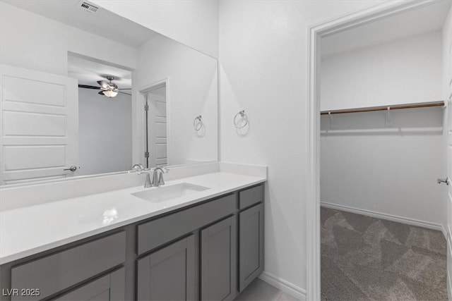 bathroom with ceiling fan and vanity