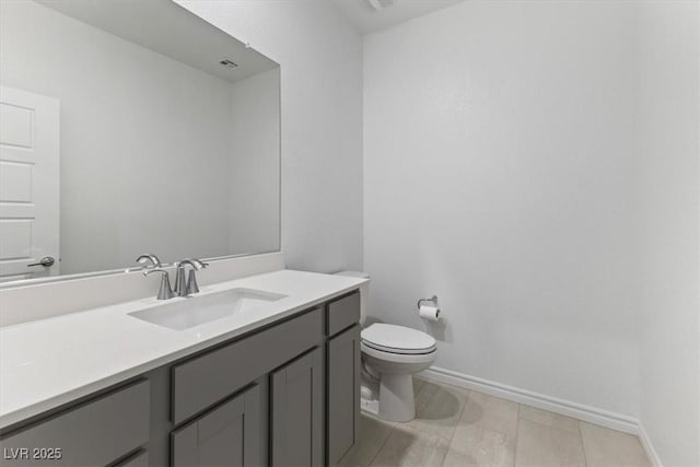 bathroom with tile patterned flooring, vanity, and toilet