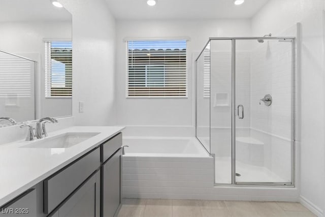 bathroom with tile patterned floors, vanity, and separate shower and tub