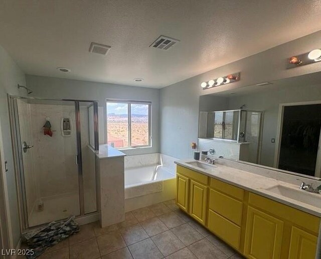 bathroom with tile patterned floors, vanity, plus walk in shower, and a textured ceiling