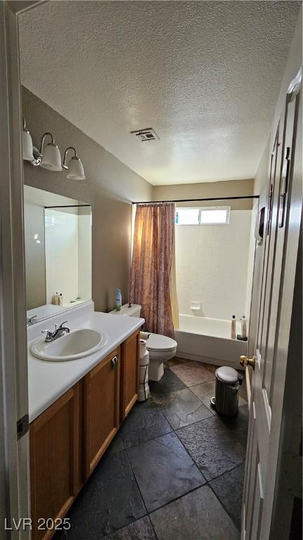 full bathroom featuring a textured ceiling, vanity, toilet, and shower / bathtub combination with curtain