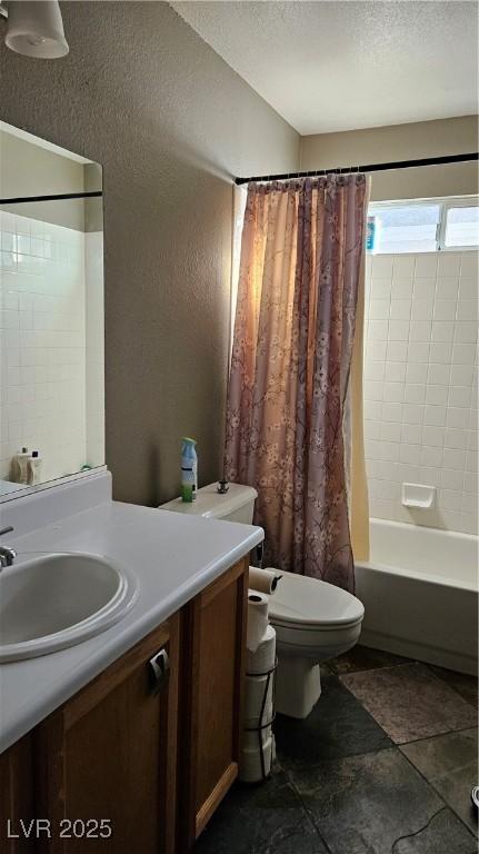 full bathroom with vanity, shower / tub combo, and toilet