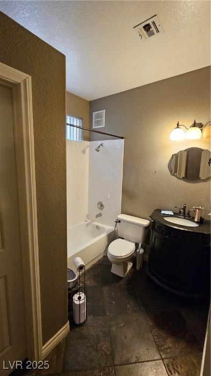 full bathroom with bathing tub / shower combination, vanity, a textured ceiling, and toilet