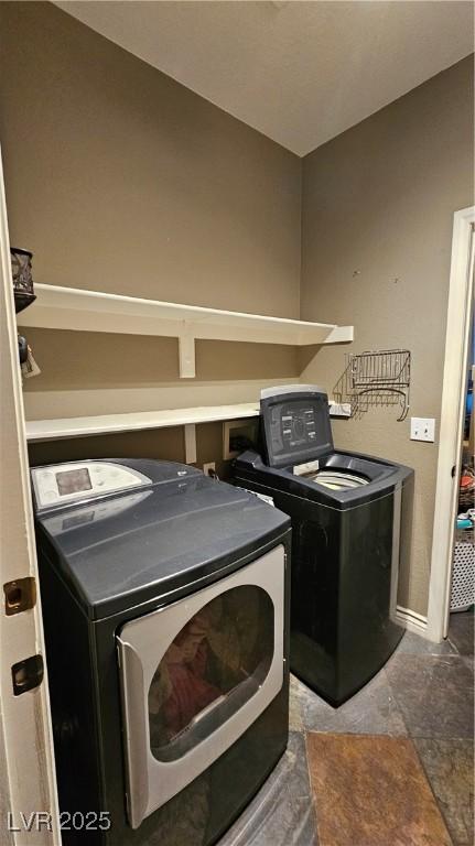 clothes washing area featuring washer and clothes dryer