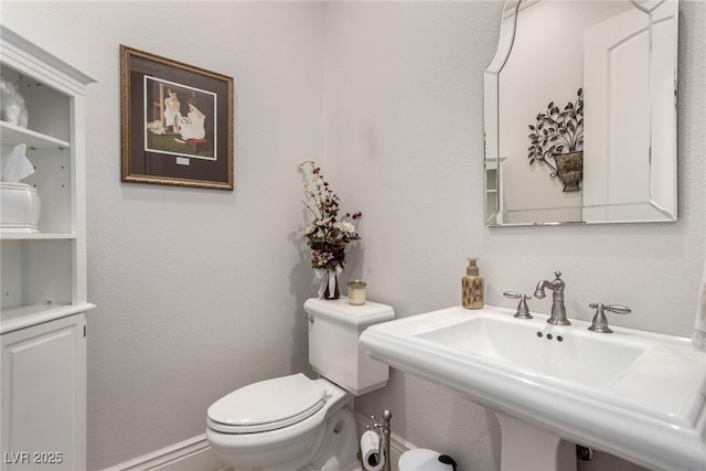 bathroom featuring toilet and sink