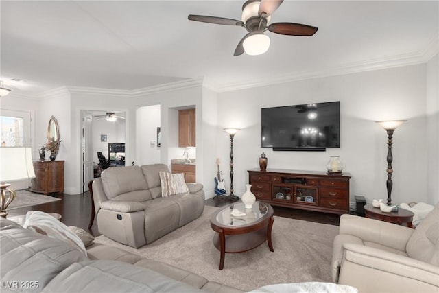 living room with hardwood / wood-style flooring, ceiling fan, and crown molding