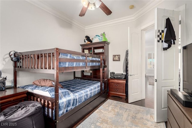 bedroom with dark hardwood / wood-style floors, ceiling fan, and ornamental molding