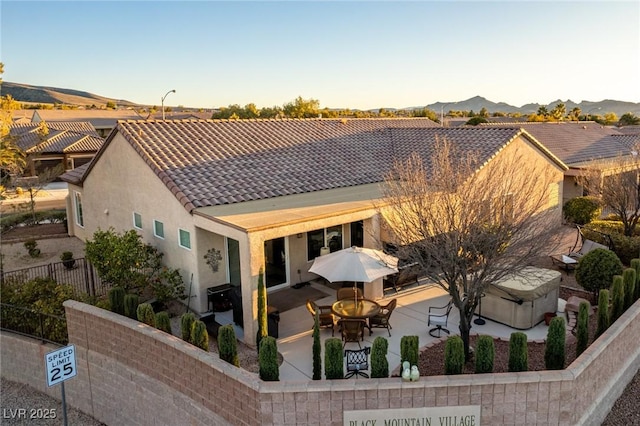 rear view of property featuring a mountain view and a patio