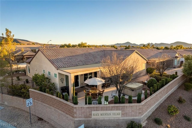 view of front of house featuring a mountain view and a patio