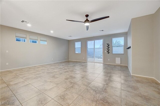 unfurnished room featuring ceiling fan and light tile patterned flooring