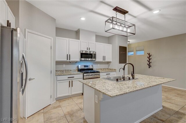 kitchen with a kitchen island with sink, white cabinets, hanging light fixtures, sink, and appliances with stainless steel finishes