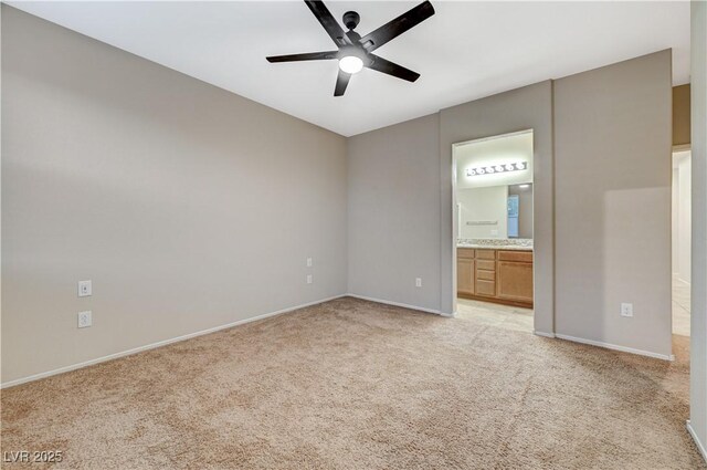 unfurnished bedroom with light carpet, ensuite bathroom, and ceiling fan