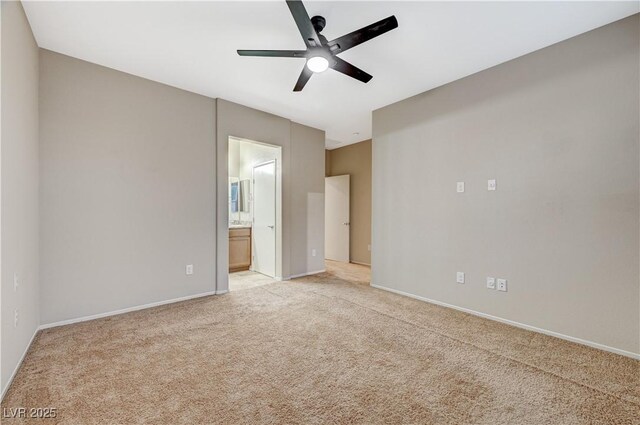 unfurnished bedroom featuring ensuite bathroom, ceiling fan, and light colored carpet