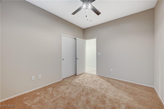 unfurnished room featuring ceiling fan and light colored carpet