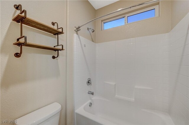 bathroom with toilet and bathing tub / shower combination