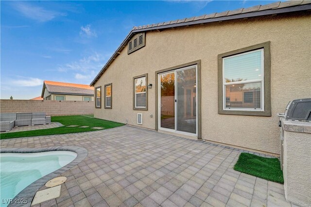 rear view of property featuring a patio