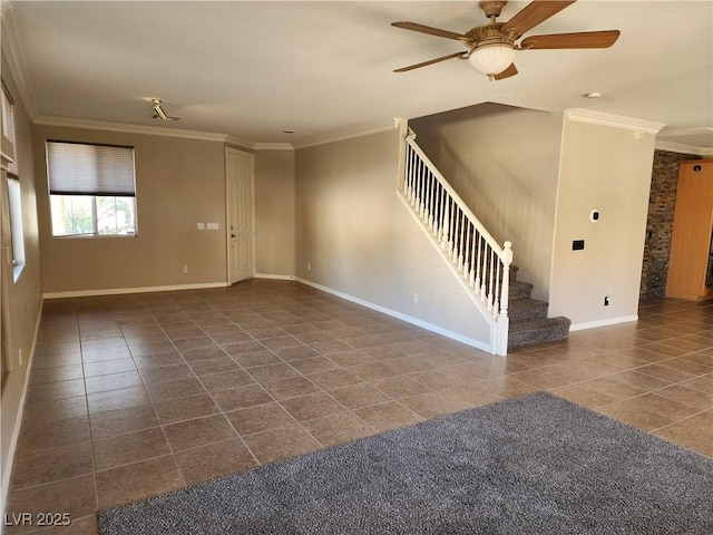 empty room featuring ceiling fan, dark tile patterned flooring, and crown molding