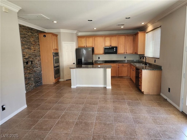 kitchen featuring dark stone countertops, stainless steel appliances, crown molding, a kitchen island, and sink