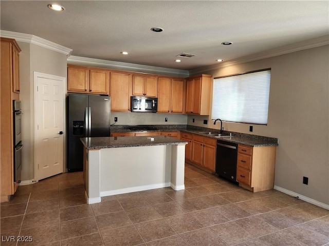 kitchen featuring black appliances, a center island, dark stone counters, ornamental molding, and sink