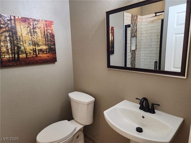 bathroom featuring sink and toilet