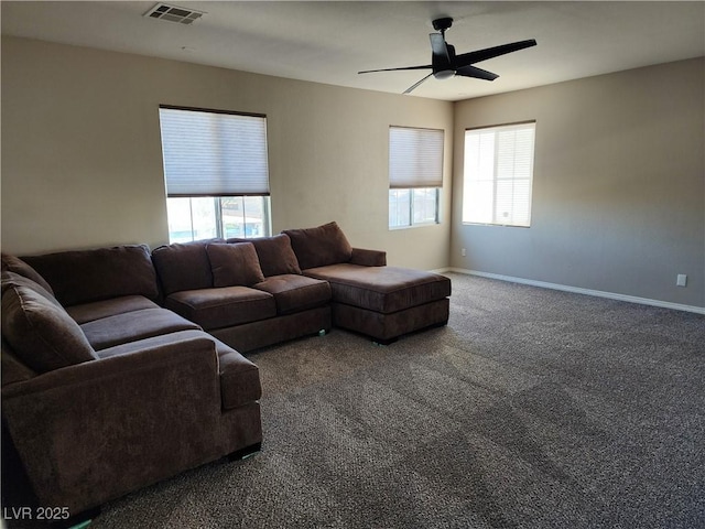 living room with carpet, ceiling fan, and plenty of natural light