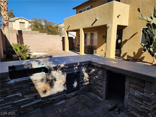 view of patio featuring exterior kitchen and a bar