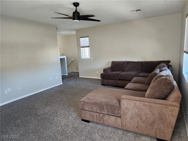 living room with ceiling fan and dark colored carpet