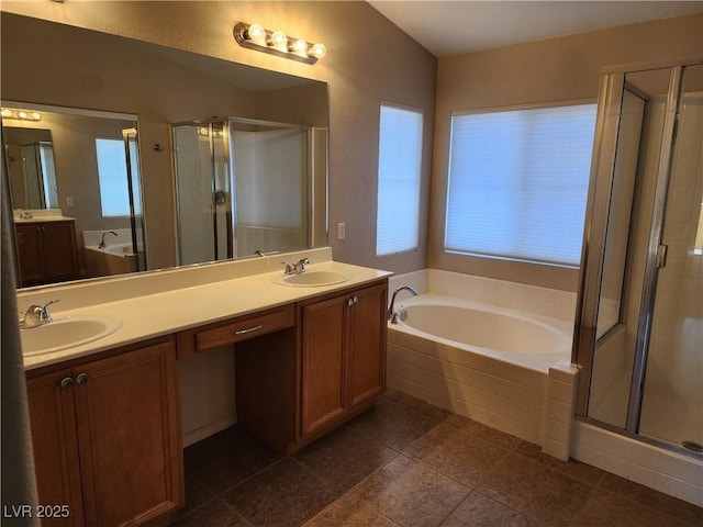 bathroom featuring independent shower and bath, plenty of natural light, and vanity