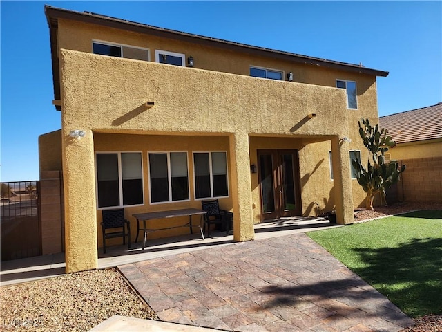 back of property with a patio