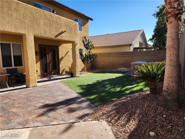 view of yard featuring a jacuzzi, a patio, and french doors