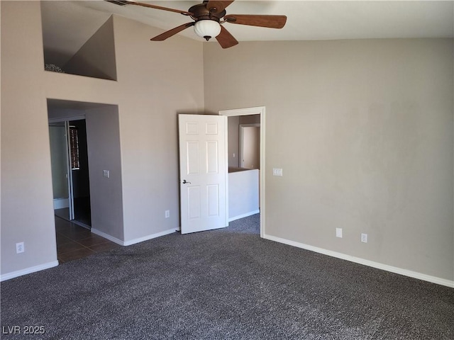 unfurnished bedroom featuring ceiling fan, high vaulted ceiling, and dark colored carpet