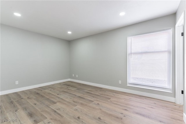 empty room with light hardwood / wood-style flooring