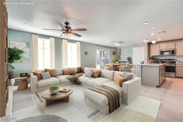 living room featuring ceiling fan and light tile patterned floors