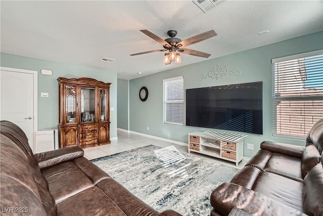 tiled living room with ceiling fan