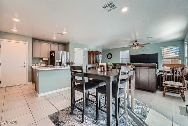 dining space featuring ceiling fan and light tile patterned floors